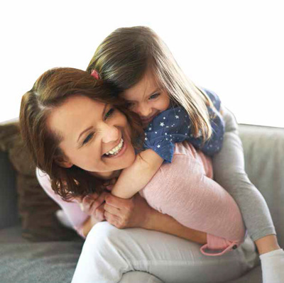 Mother daughter together on couch